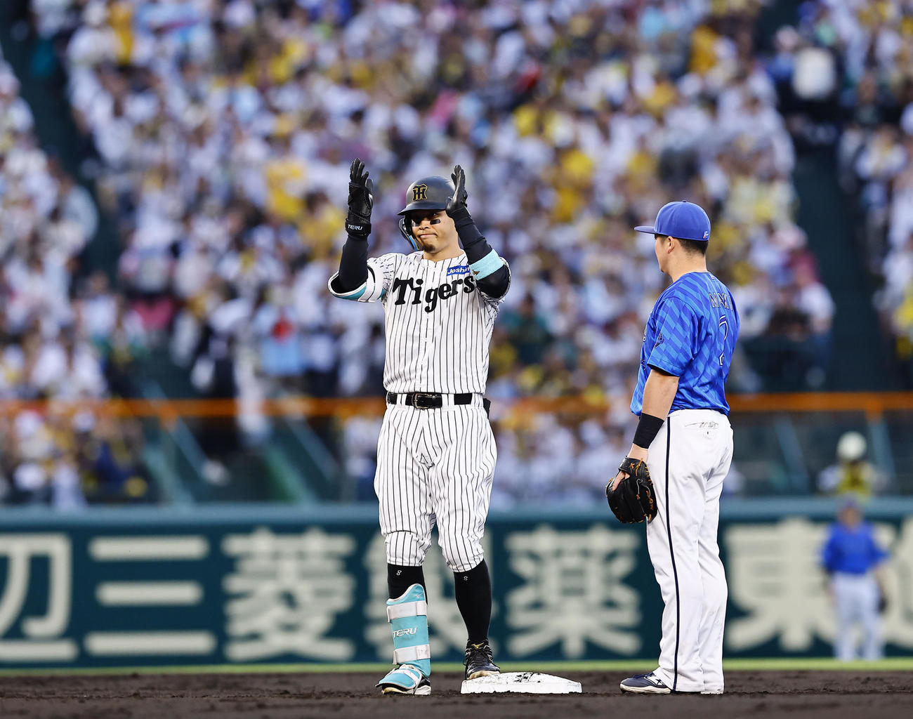 阪神対DeNA 2回裏阪神無死、佐藤輝は左越えに二塁打を放ち手をたたく（撮影・藤尾明華）