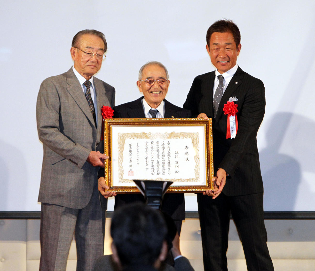 12年11月、「現代の名工」の受賞パーティーで写真に納まる江頭重利氏（中央）。左は広岡達朗氏、右は辻発彦氏