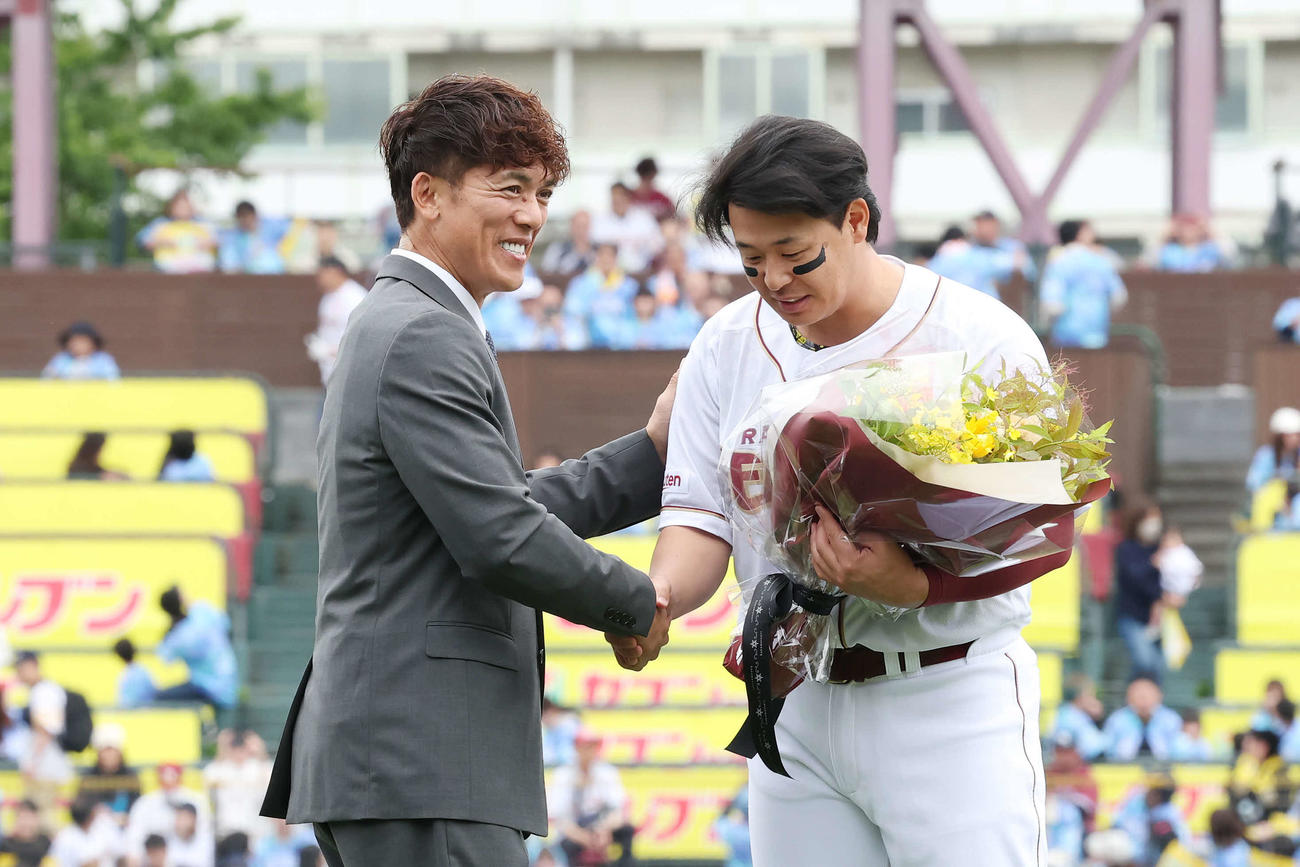 楽天対ソフトバンク　試合前、通算2000安打で連盟表彰を受けた楽天浅村（右）は松井氏と握手（撮影・宮地輝）