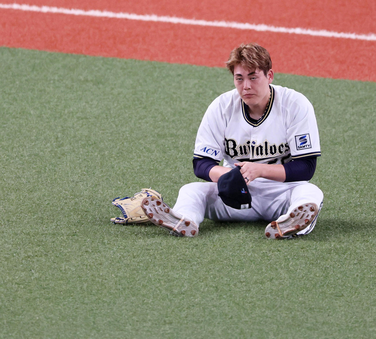オリックス対広島　5回表広島2死一、三塁、九里は野間の打球を捕球できず適時内野安打となり失点しグラウンド上に腰を下ろす（撮影・加藤哉）