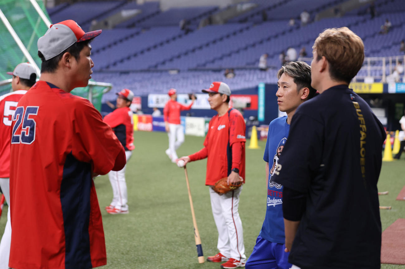 オリックス対広島　試合前の練習中、広島新井貴浩監督（左）は右からオリックス西川、九里と話す（撮影・西尾就之）
