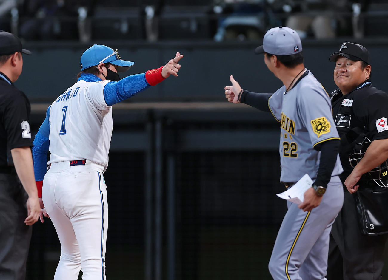 日本ハム対阪神　試合前のメンバー表交換でハイタッチを交わした日本ハム新庄監督（左）と阪神藤川監督（撮影・前田充）