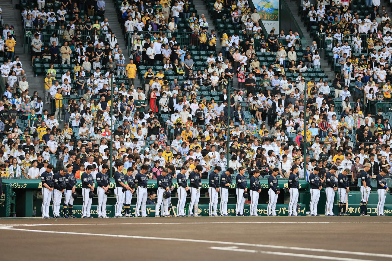 阪神対オリックス　亡くなった長嶋茂雄巨人終身名誉監督に向け、半旗が掲げられた甲子園球場で黙とうするオリックスナイン（撮影・宮崎幸一）