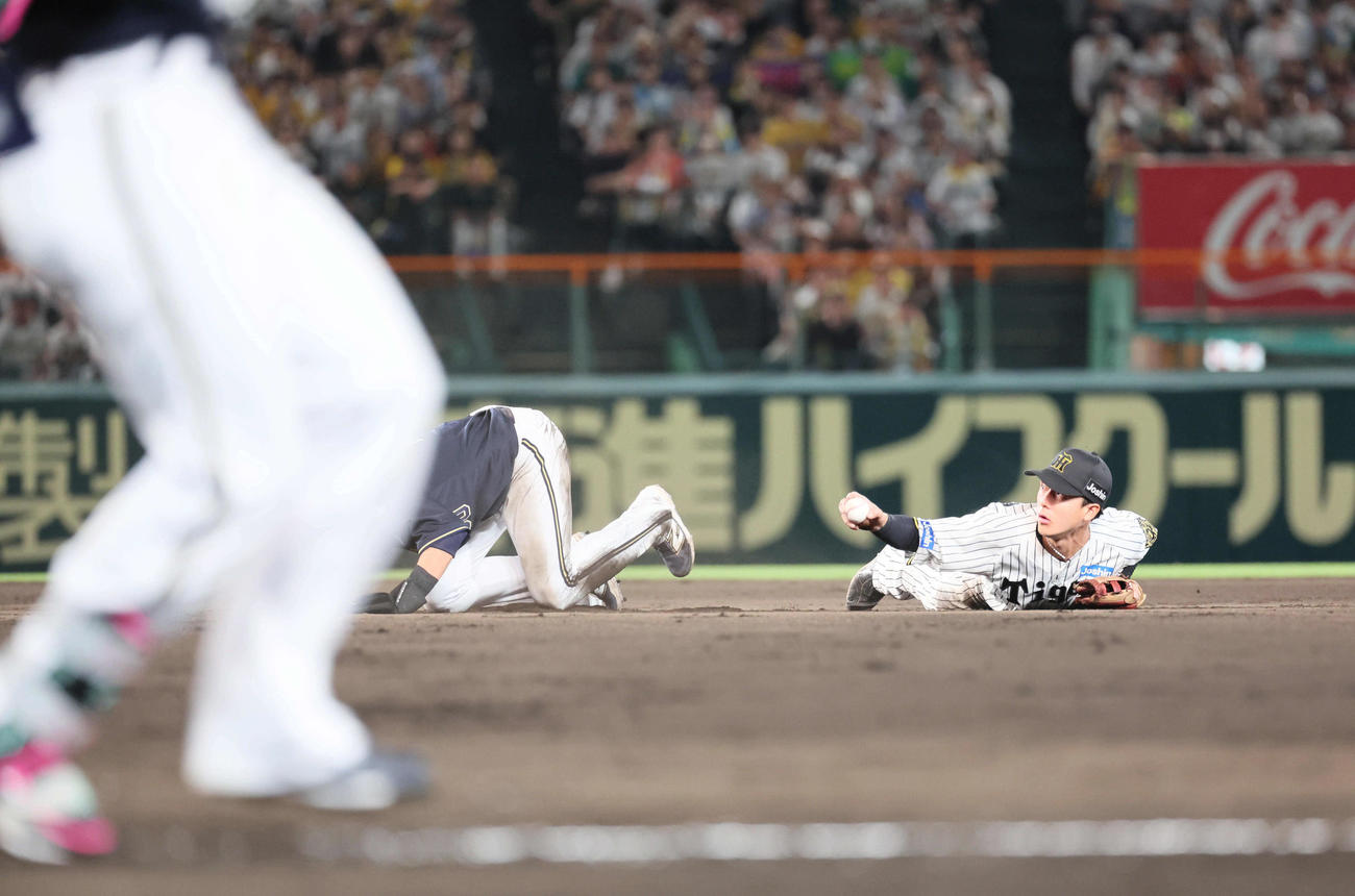 阪神対オリックス　9回表オリックス無死一塁、西川の二塁への打球で併殺を狙った小幡は、広岡のスライディングで一塁へ送球できず。リプレイ検証で守備妨害が認められる（撮影・宮崎幸一）