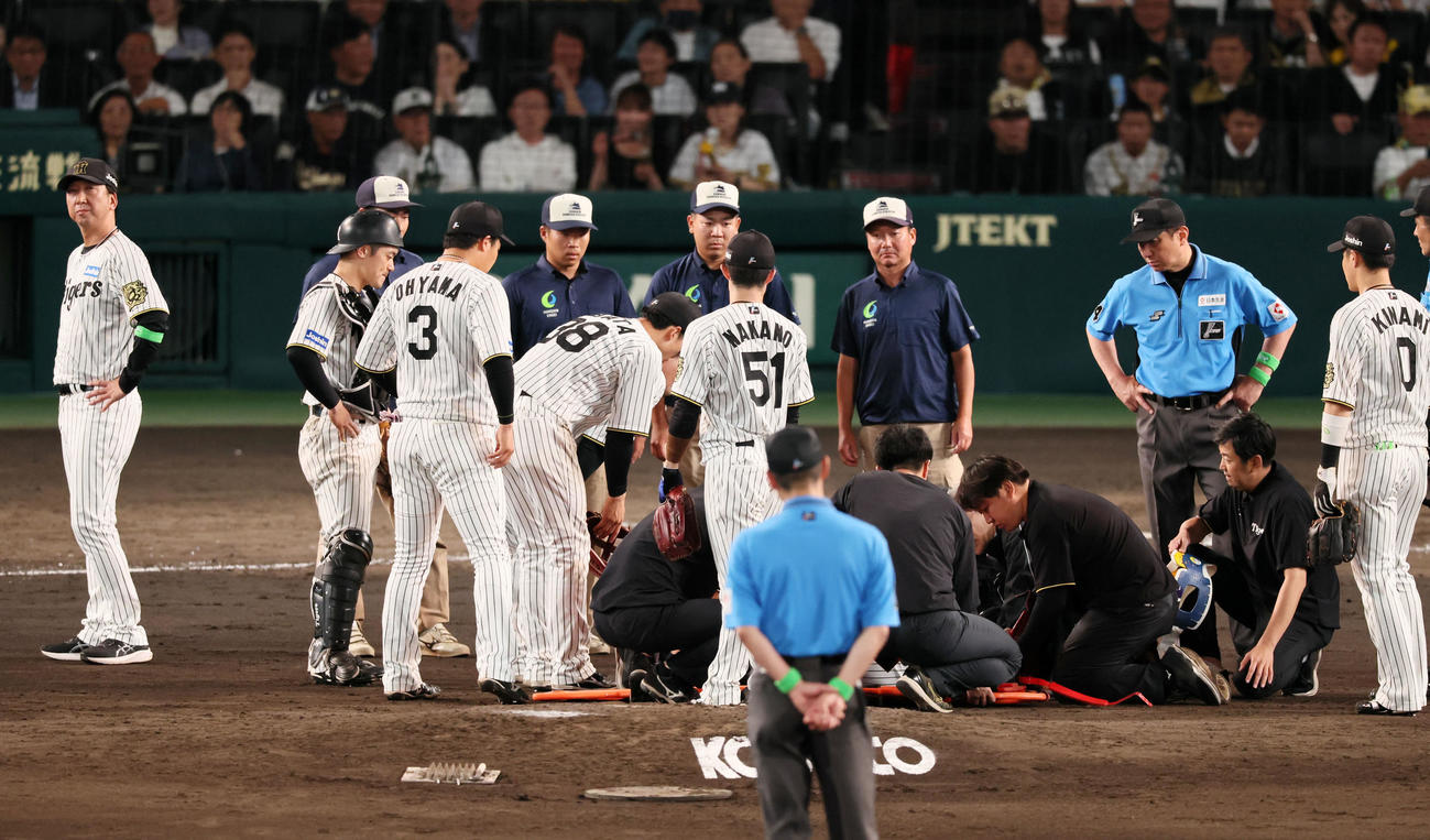 阪神対オリックス　9回表オリックス無死、石井が広岡の打球を頭部に受け担架が用意されるマウンド横で腰に手を当てる藤川監督（撮影・加藤哉）