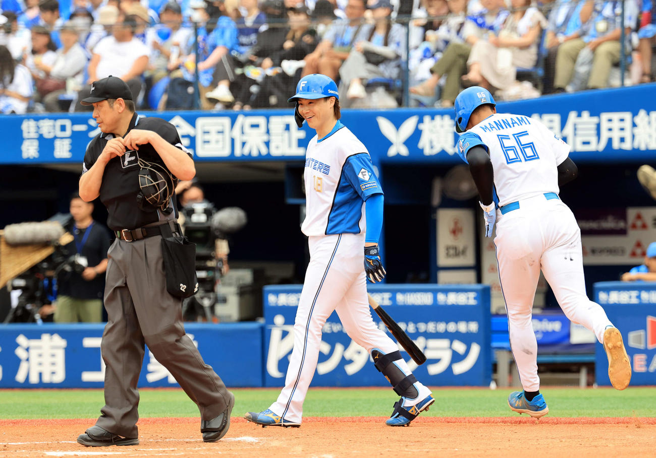 DeNA対日本ハム　7回表日本ハム1死一、二塁、万波（右）に申告敬遠を出され、思わず笑みを浮かべる山崎（撮影・浅見桂子）