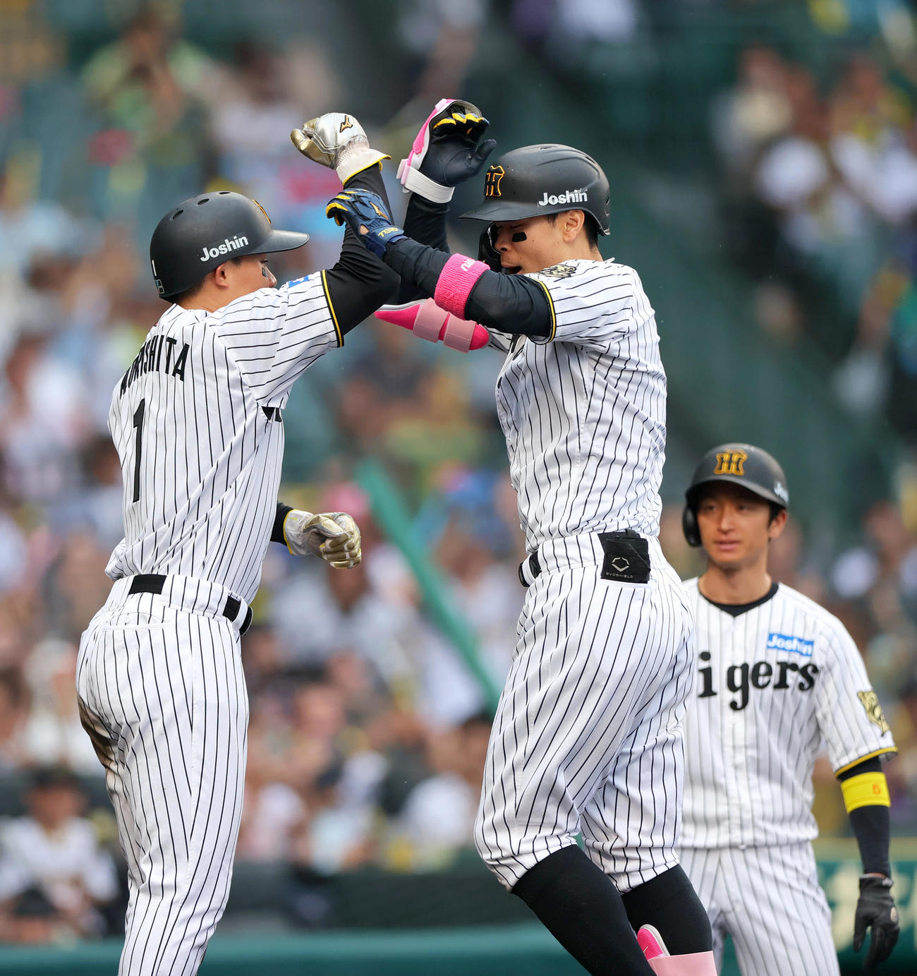 阪神対オリックス　8回裏阪神1死満塁、佐藤輝（中央）は中越え満塁本塁打を放ち森下とタッチをかわす（撮影・上山淳一）