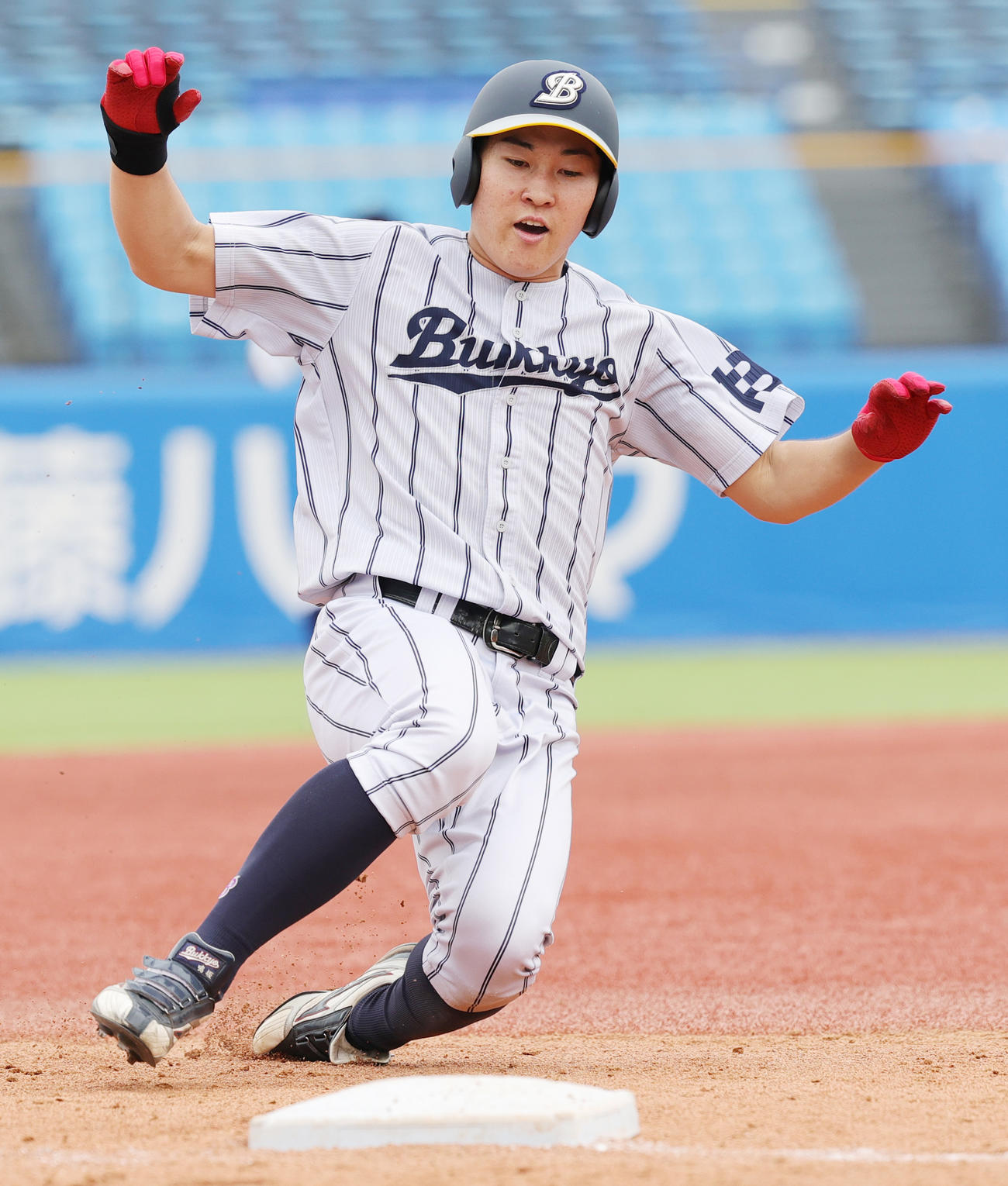 佛教大対北海学園大　4回表佛教大2死二塁、右適時三塁打を放ち滑り込む鳴坂（撮影・野上伸悟）