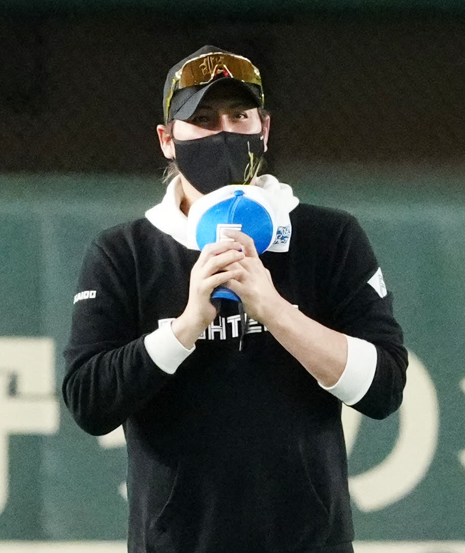 巨人対日本ハム　試合前練習を終え引き揚げる日本ハム北山の帽子のつばを曲げる新庄監督（撮影・江口和貴）