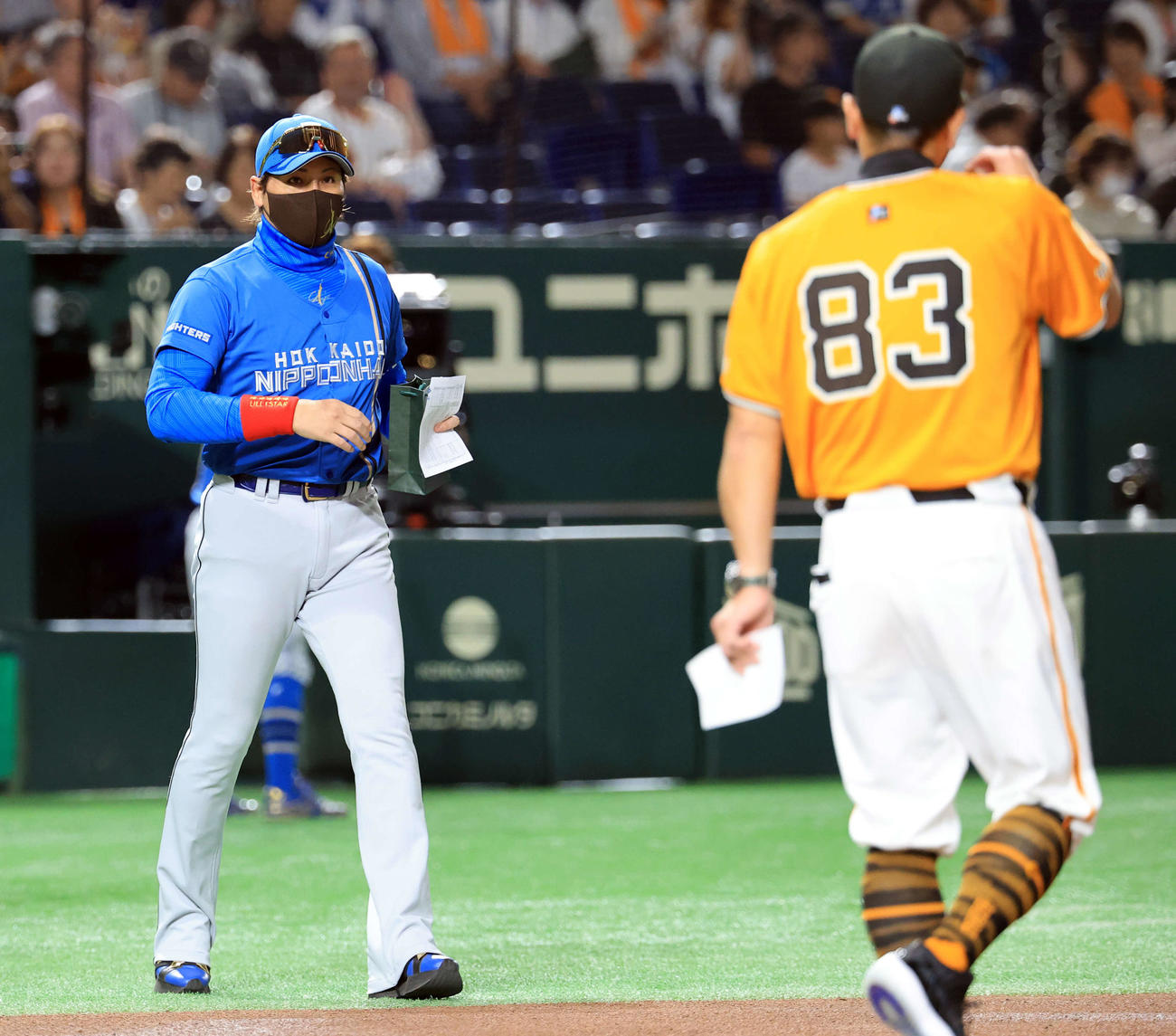 18日の巨人対日本ハム戦争で、お土産を手に巨人阿部監督（手前）のもとに向かう日本ハム新庄監督（撮影・浅見桂子）