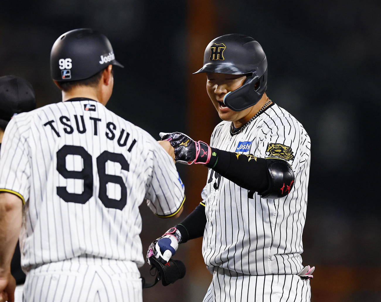阪神対ロッテ　7回裏阪神2死一、二塁、大山は中前適時打を放ちタッチを交わす（撮影・藤尾明華）