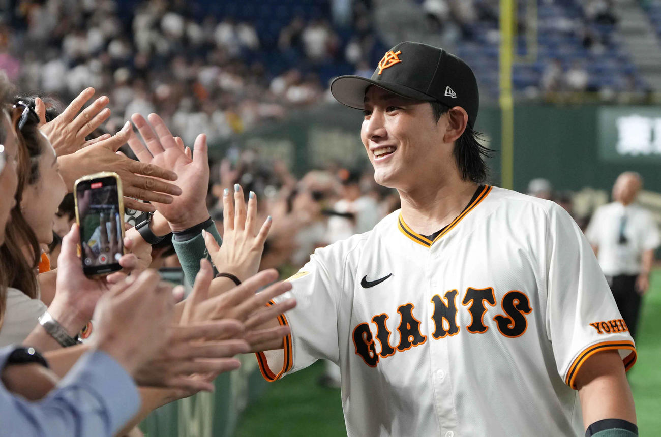 今季初スタメンで勝利に貢献した巨人小林はファンとハイタッチ（撮影・小沢裕）