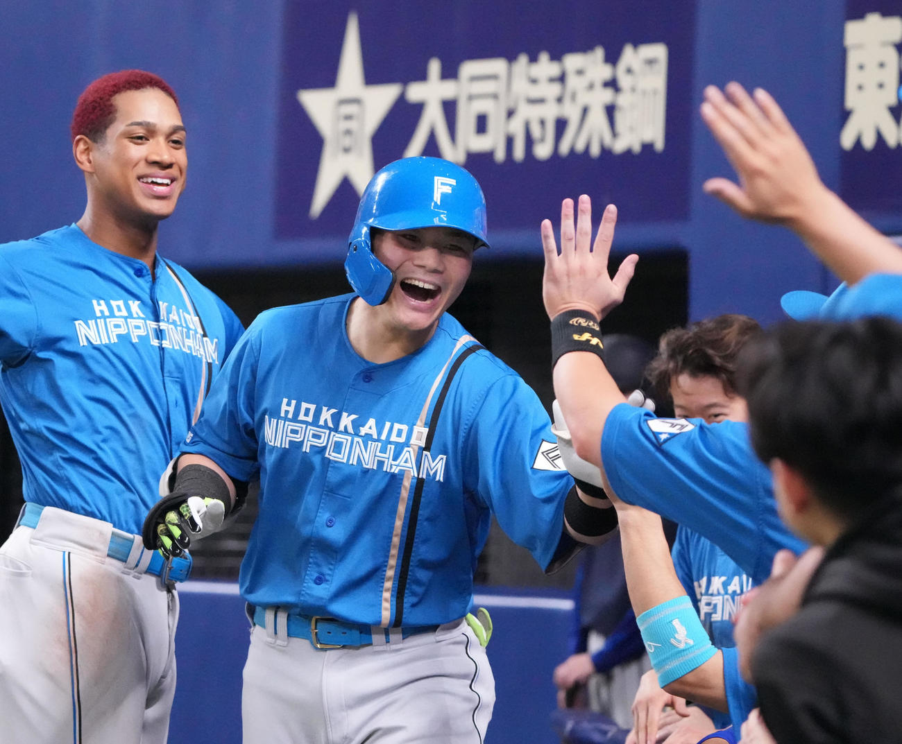 中日対日本ハム　7回表日本ハム2死、清宮（中央）は右越え本塁打を放ちナインとタッチを交わす（撮影・森本幸一）