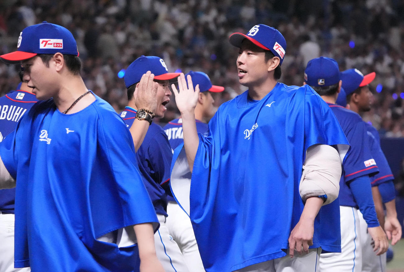 中日対日本ハム　試合終了、松葉（中央）はナインとタッチを交わす（撮影・森本幸一）