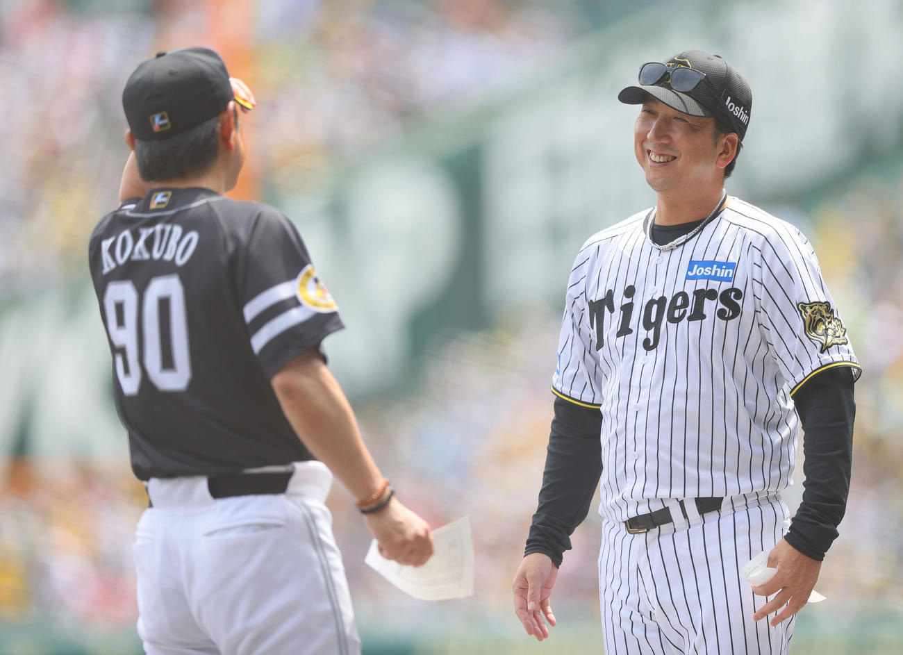 阪神対ソフトバンク　メンバー表の交換で笑顔を見せる阪神藤川監督（右）とソフトバンク小久保監督（撮影・上山淳一）