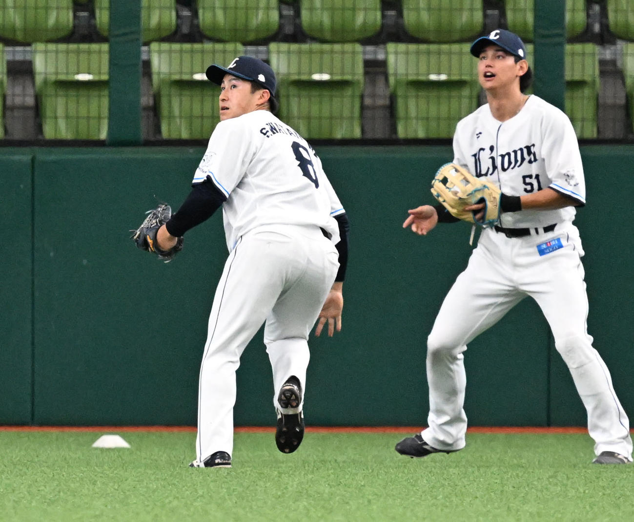 外野の守備練習で、飛球を追う渡部聖。右は西川（撮影・千葉一成）