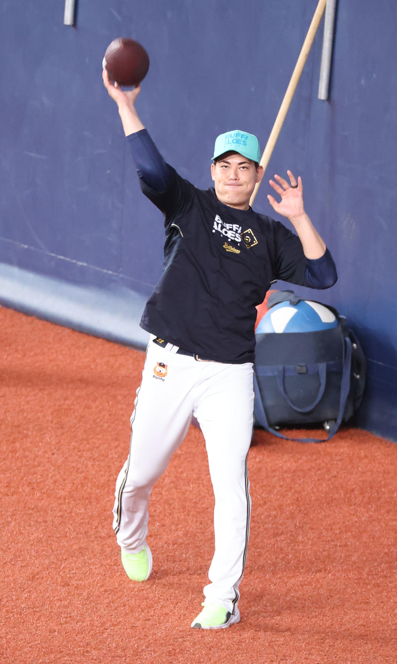アメフトのボールを投げるオリックス九里（撮影・西尾就之）