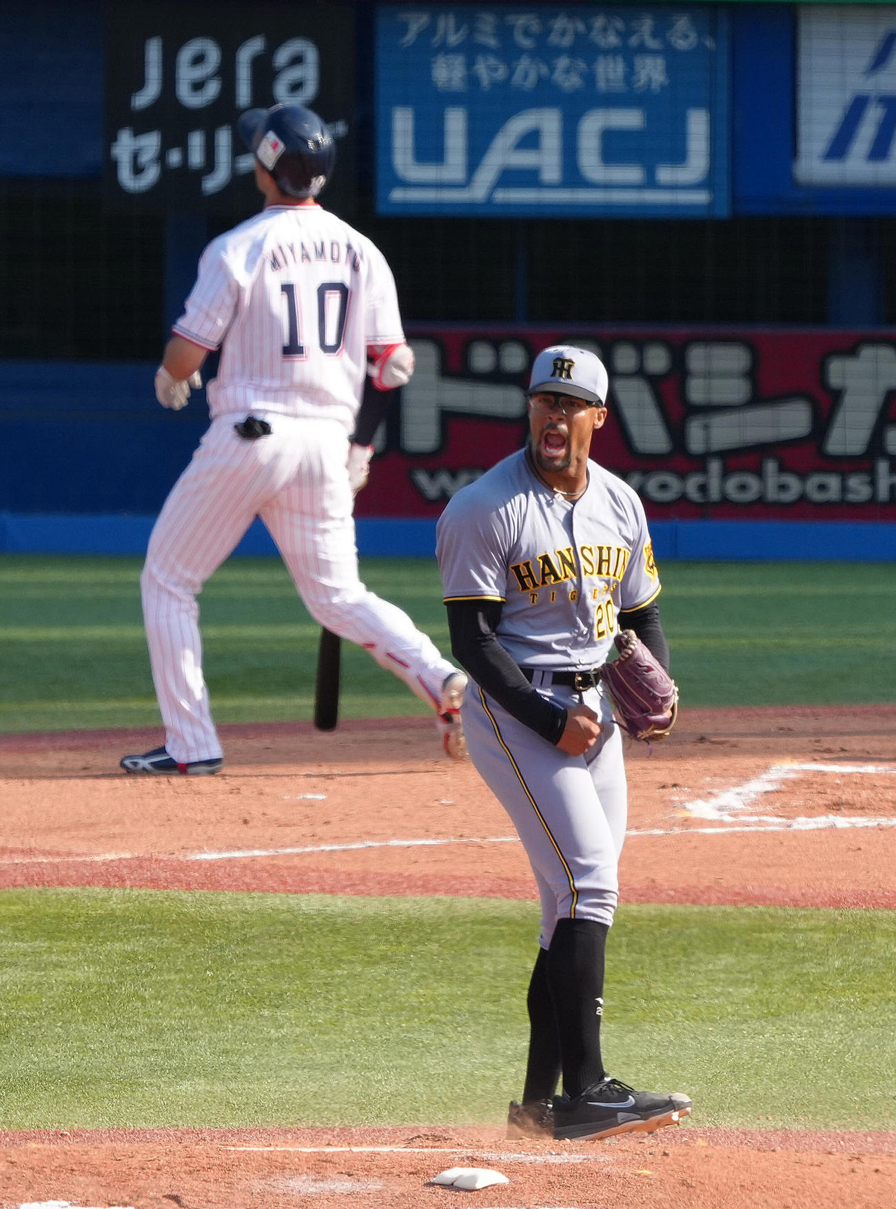 ヤクルト対阪神　7回裏ヤクルト2死、宮本（後方）を空振り三振に仕留めたデュプランティエは雄たけびガッツポーズ（撮影・足立雅史）