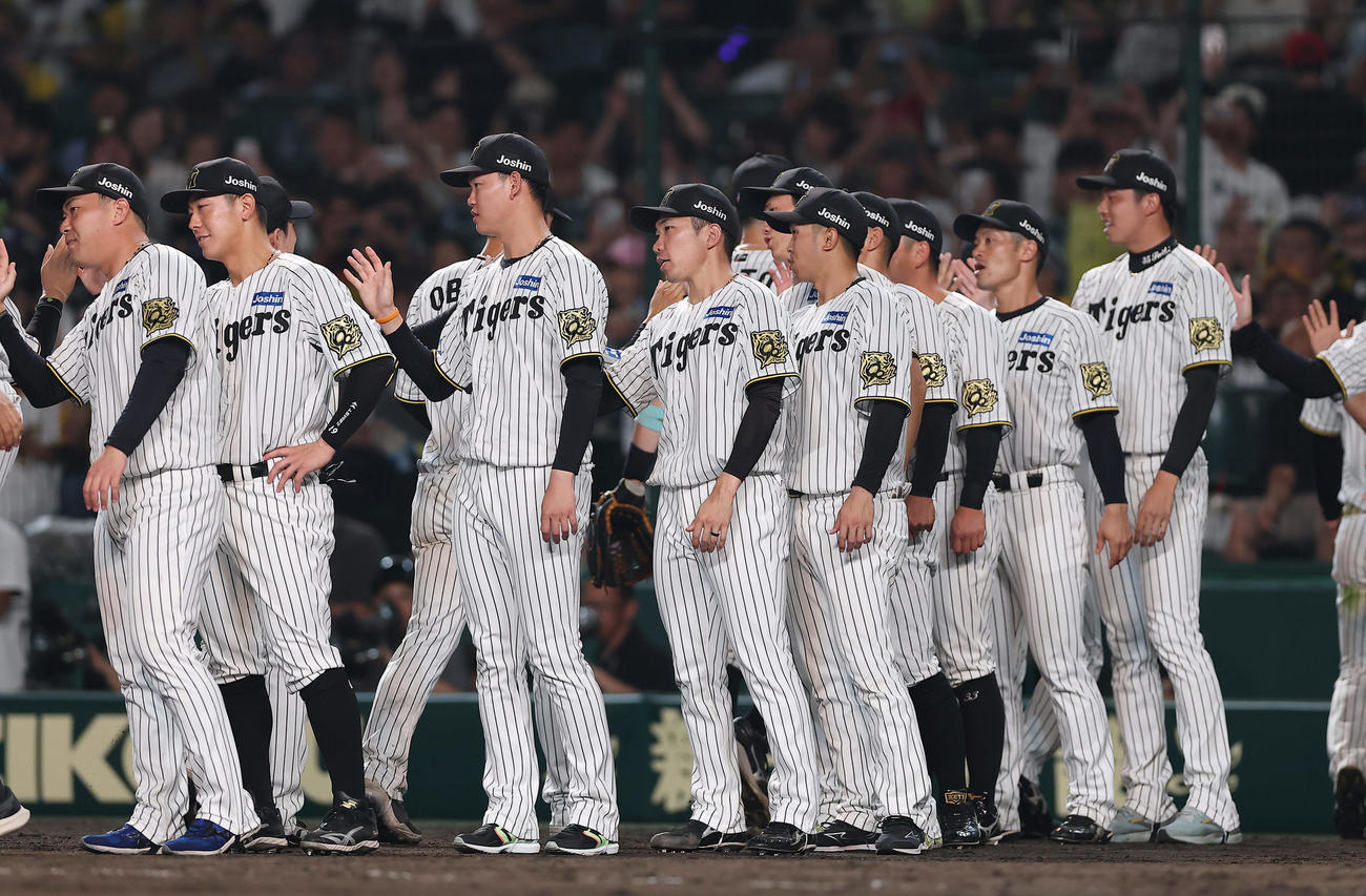 阪神対巨人　巨人に勝利し、ナインを出迎える石井（中央）ら阪神の選手たち（撮影・前田充）
