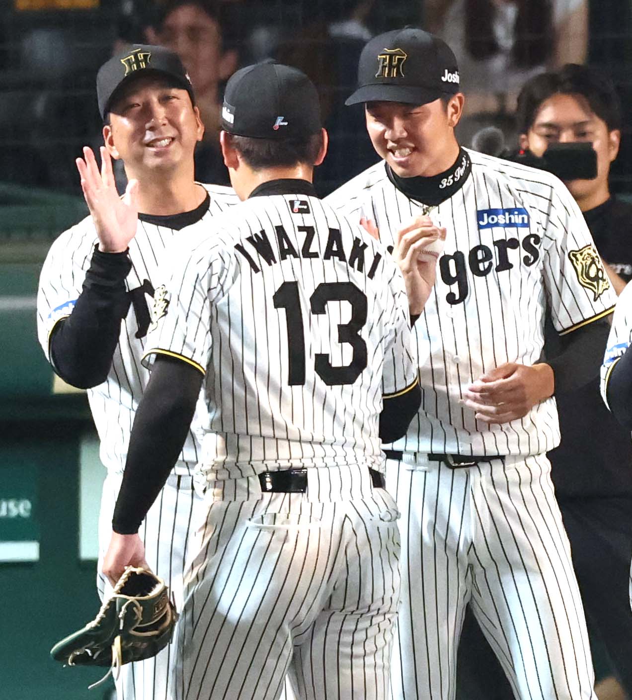 阪神対巨人　才木（右）は岩崎（中央）から勝利球を受け取る。左は藤川監督（撮影・上田博志）
