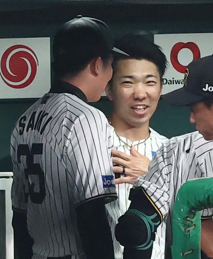 阪神対巨人　8回を無失点に抑えた石井（右）は才木と笑顔で話をする（撮影・上田博志）