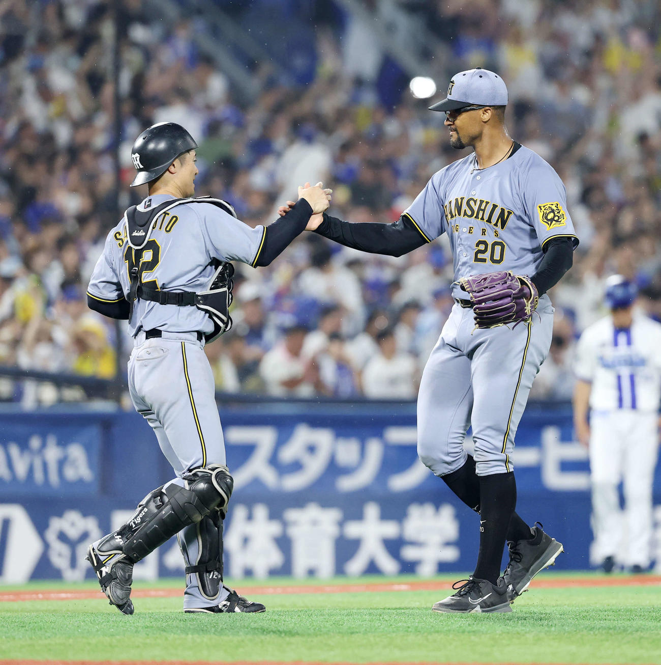 DeNA対阪神　勝利しタッチする阪神坂本（左）デュプランティエ（撮影・鈴木正人）