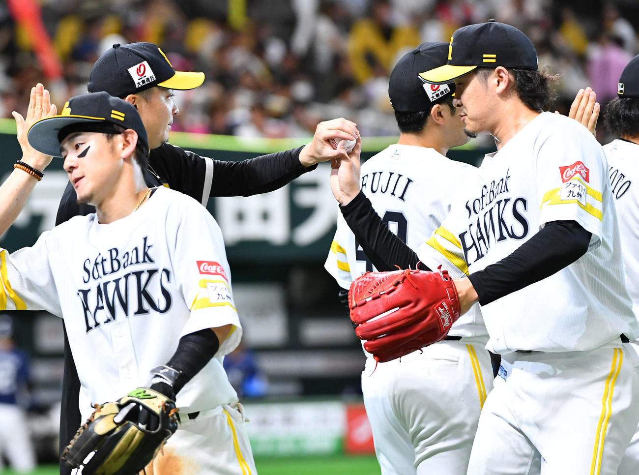 ソフトバンク対西武　今季3勝目を挙げた東浜（左から2人目）は杉山からウイニングボールを受け取る（撮影・岩下翔太）