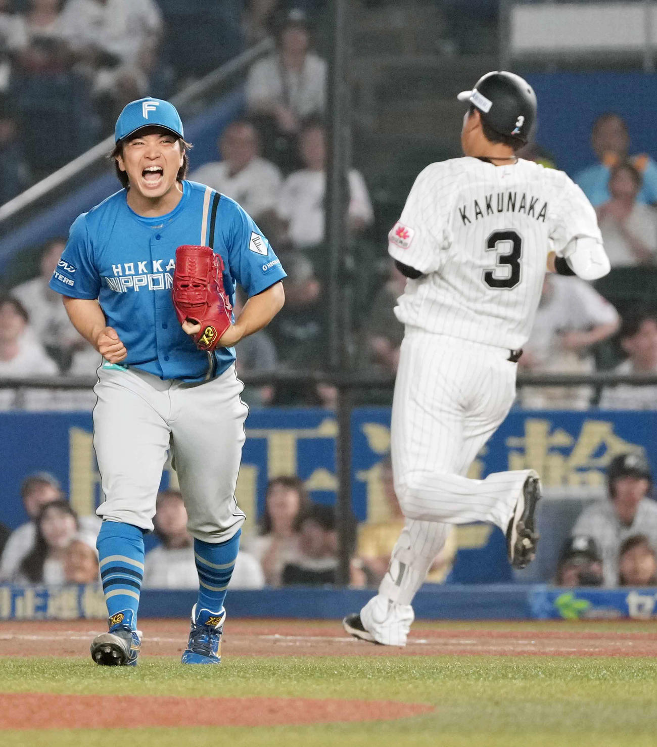 ロッテ対日本ハム　延長11回裏ロッテ2死一、三塁、日本ハム8番手で登板した山本拓（左）は代打角中を一ゴロに仕留めガッツポーズ（撮影・小沢裕）