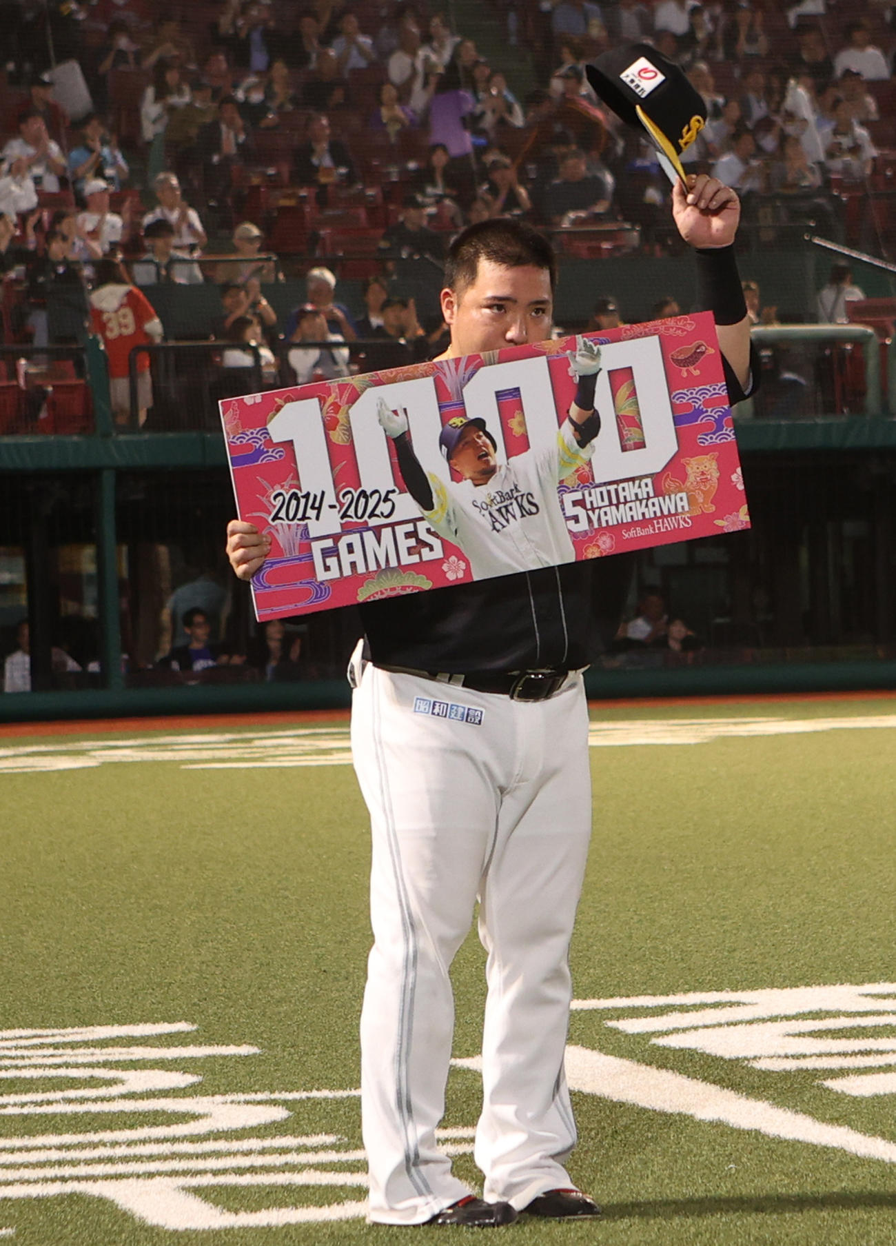楽天対ソフトバンク　5回裏が終了し1000試合出場のボードを受け取る山川（撮影・水谷安孝）