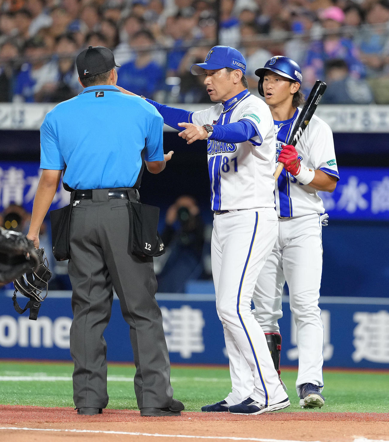 DeNA対巨人　10回裏DeNA1死、井上（右）の空振り三振判定を確認する三浦監督（撮影・足立雅史）