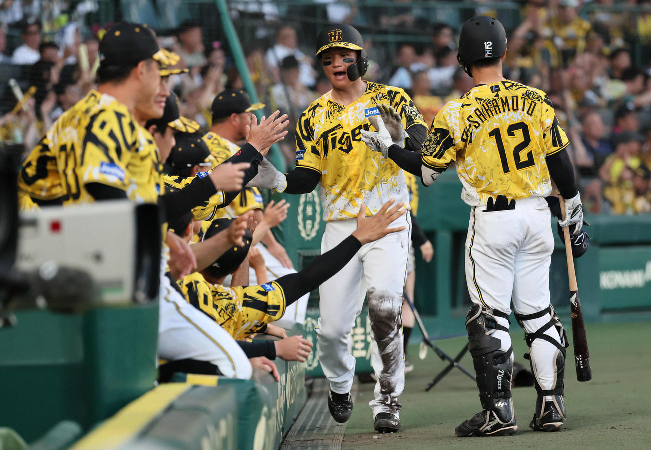 阪神対ヤクルト　4回裏阪神無死満塁、森下は大山の右前同点2点適時打で生還し、ナインに迎えられる（撮影・宮崎幸一)