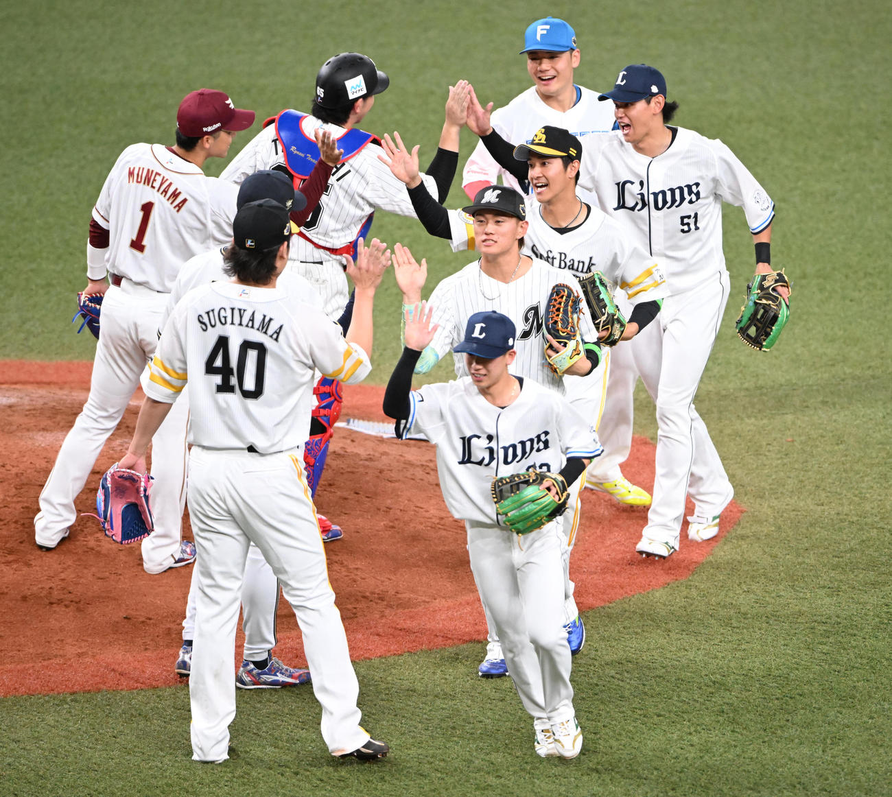 全パ対全セ　全セに勝利しハイタッチする西武西川（右）ら全パの選手ら（撮影・和賀正仁）