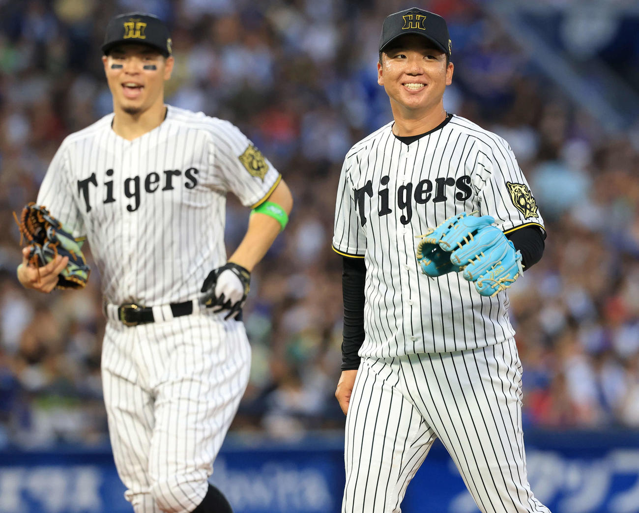 全セ対全パ　1回表全パも3点を献上し、苦笑いでベンチに戻る村上（右）。左は佐藤輝（撮影・浅見桂子）