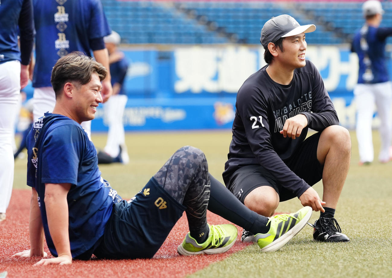 ロッテ対オリックス　試合前練習でオリックス岩崎（左）と談笑するロッテ石川柊（撮影・鈴木みどり）