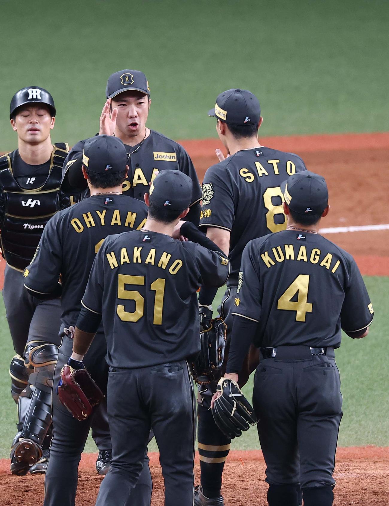 阪神対ヤクルト　38試合連続無失点を達成した石井（中央）はナインとハイタッチする（撮影・上田博志）