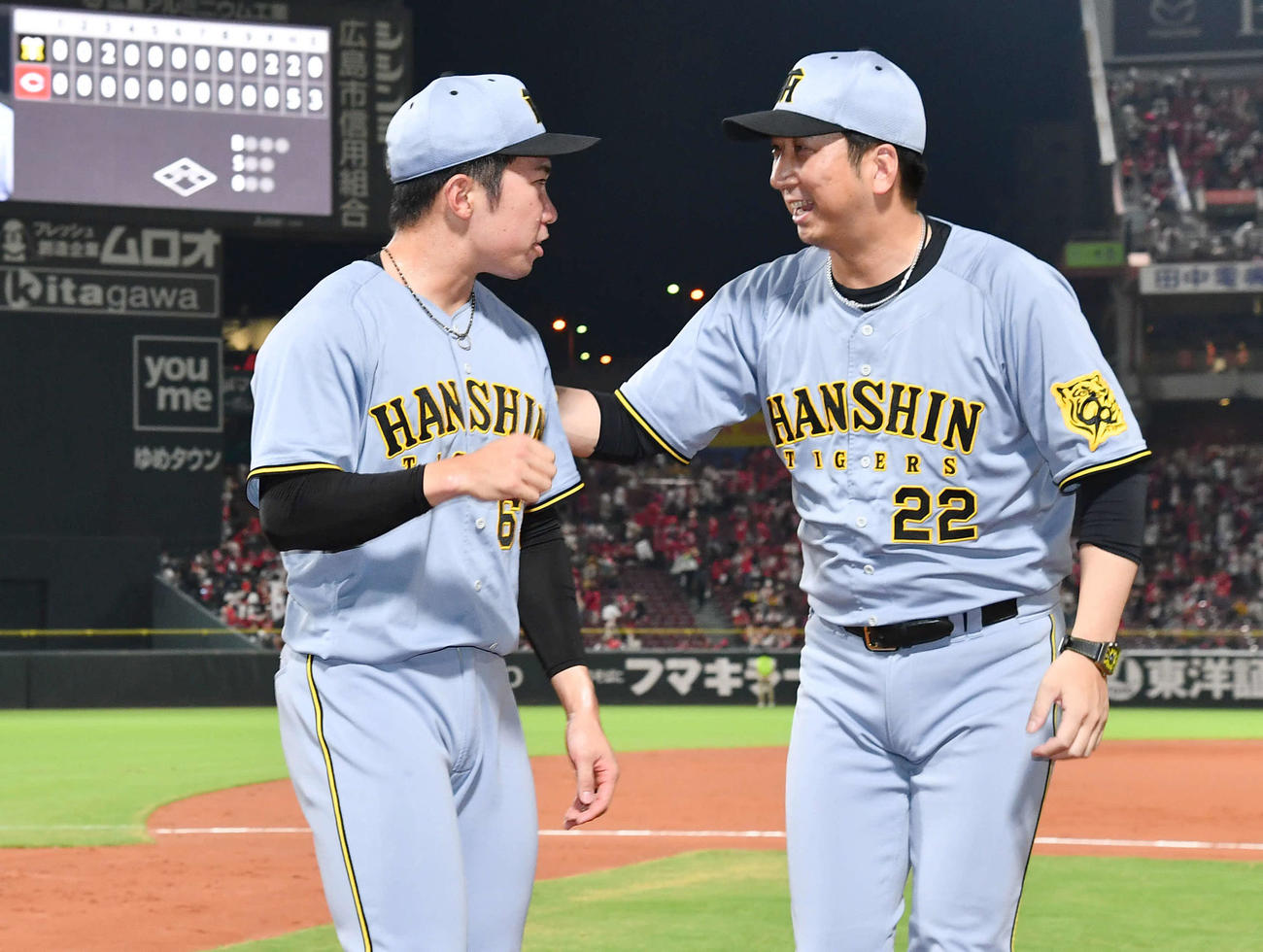 広島対阪神　セリーグ新記録となる39試合連続無失点を達成した石井（左）を祝福する藤川監督（撮影・岩下翔太）