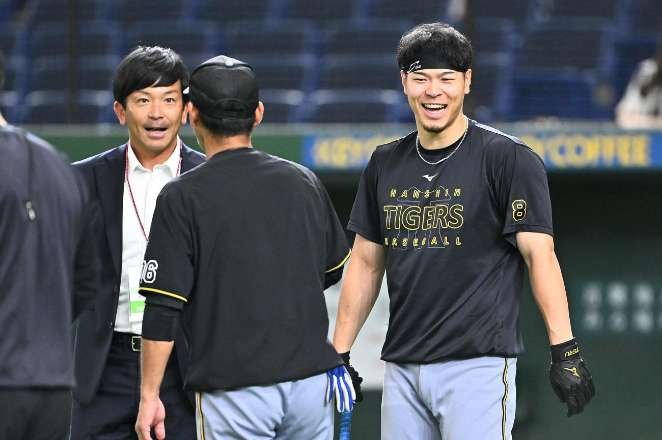 巨人対阪神　試合前練習で松田氏（左）と談笑する阪神佐藤輝（右）（撮影・滝沢徹郎）