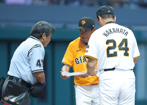 巨人OB対巨人女子軟式野球チーム　開始前、メンバー表交換する巨人OB中畑監督（手前）と巨人女子軟式野球チーム宮本監督（撮影・河田真司）