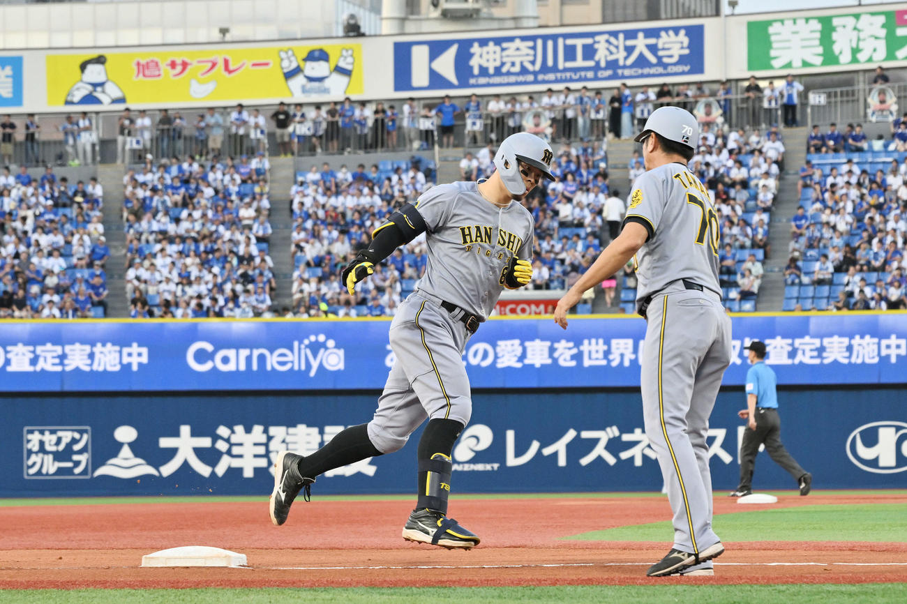 DeNA対阪神　1回表阪神2死二塁、先制2点本塁打を放った佐藤輝（左）は田中コーチとタッチを交わす（撮影・滝沢徹郎）