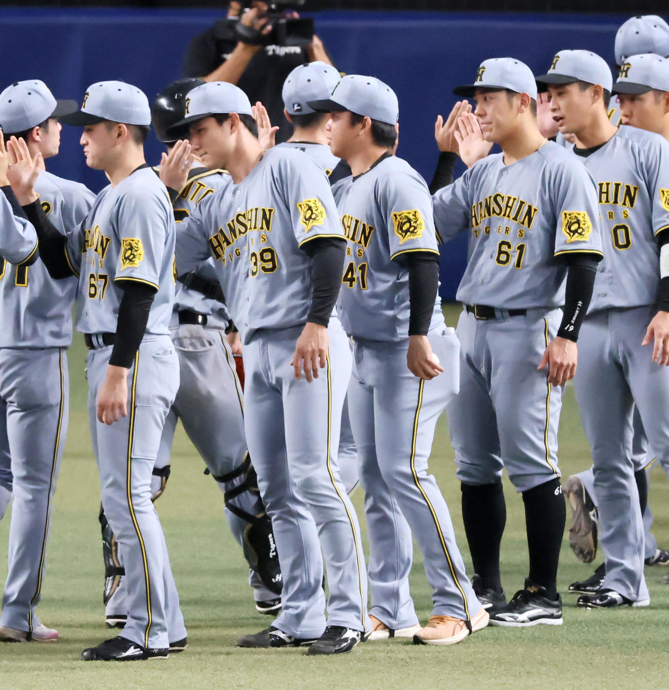中日対阪神　中日に勝利しウイニングボールを手にナインとタッチする村上（撮影・加藤哉）