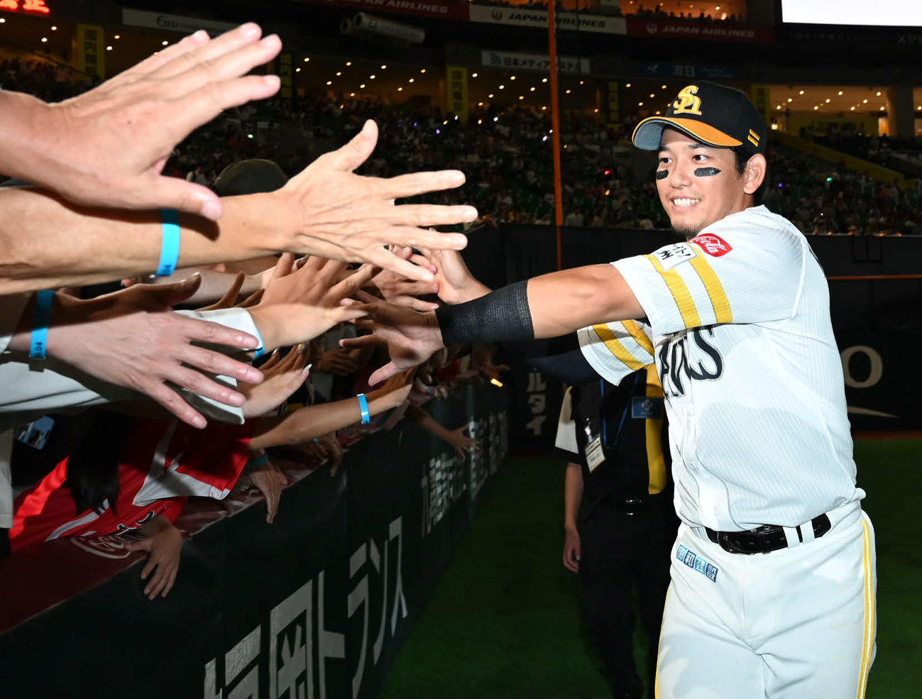 ソフトバンク対オリックス　ファンとタッチを交わす栗原（撮影・林敢治）