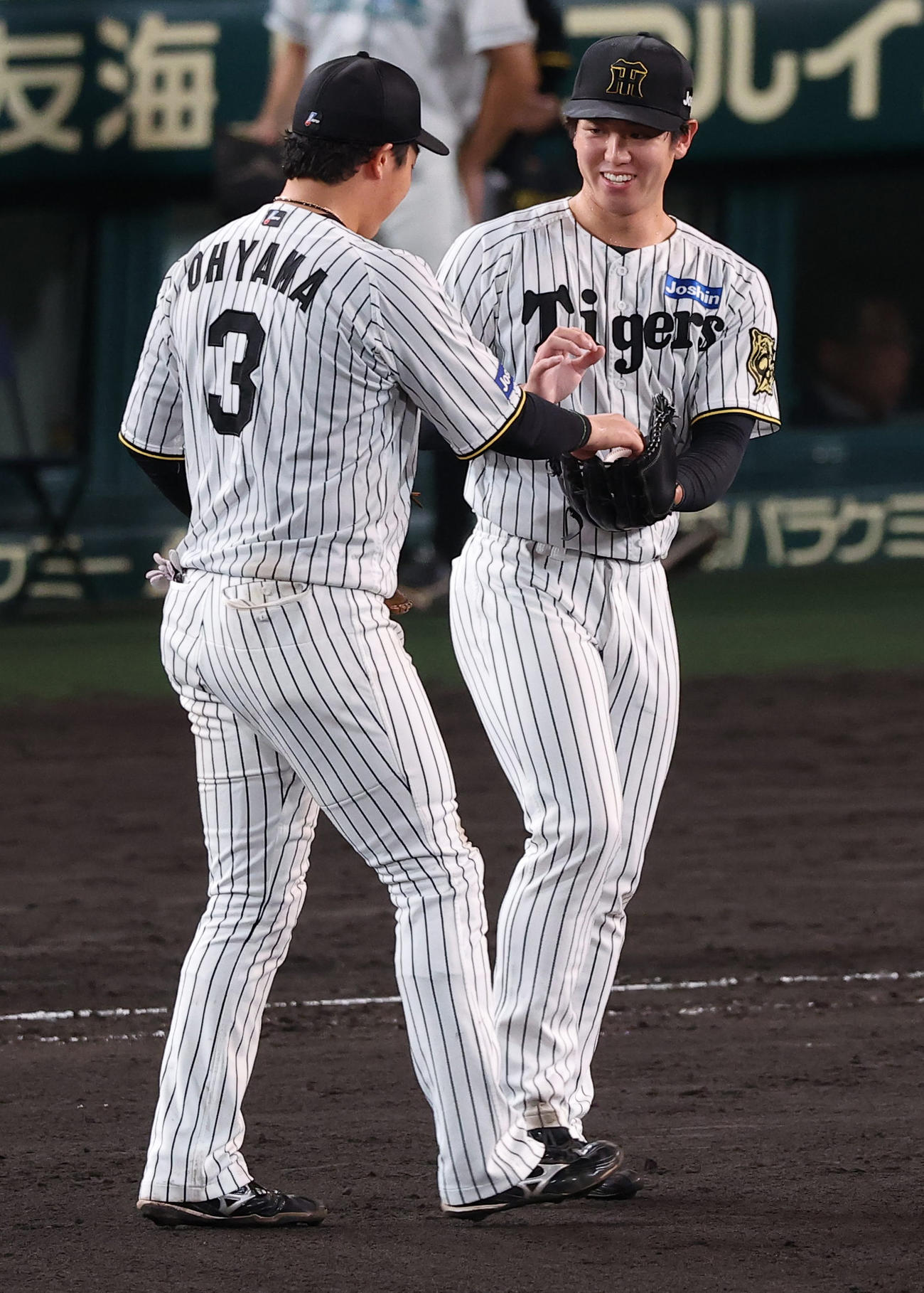阪神対広島　9回を無失点に抑えた石黒（右）は大山から勝利球を受け取る（撮影・上田博志）