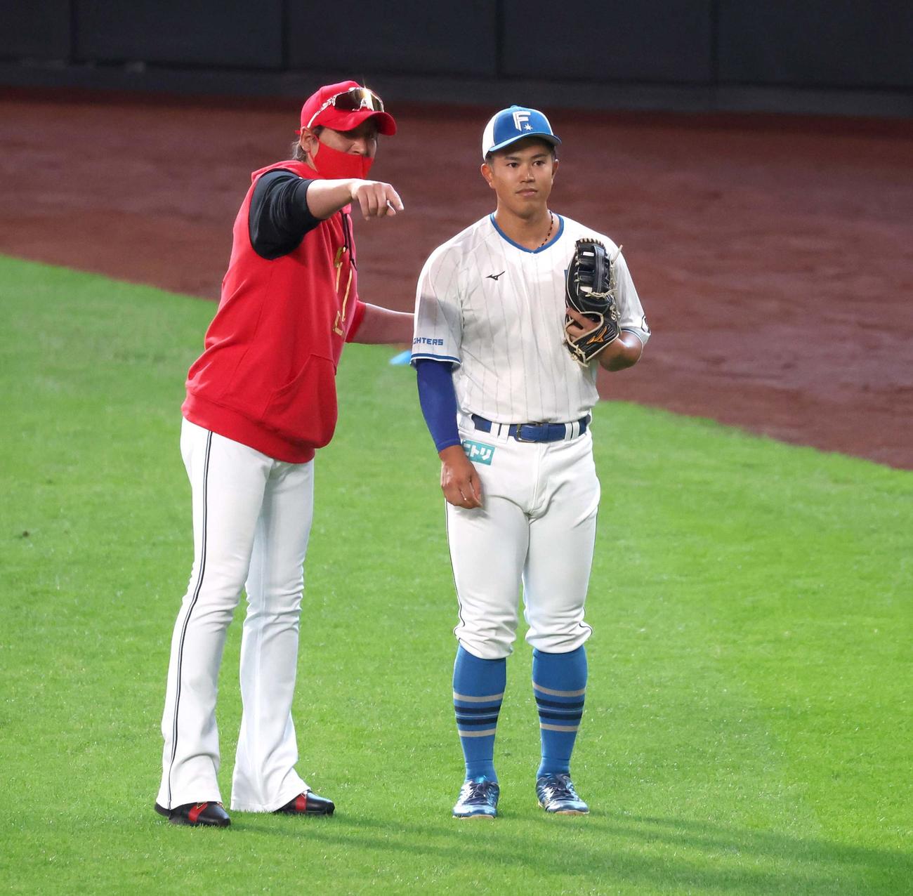 日本ハム対西武　今川（右）に送球の指導をする新庄監督（撮影・黒川智章）