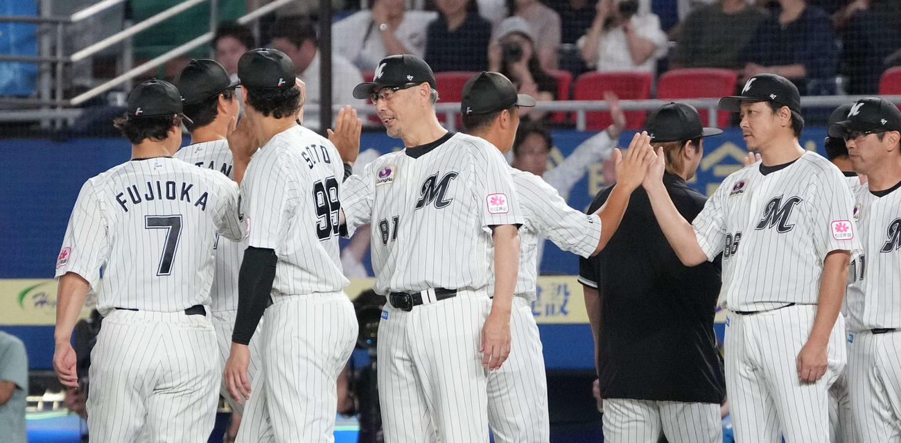 ロッテ対楽天　樂天に快勝を収めナインとハイタッチするロッテ吉井監督（中央）。右はサブローヘッドコーチ（撮影・小沢裕）