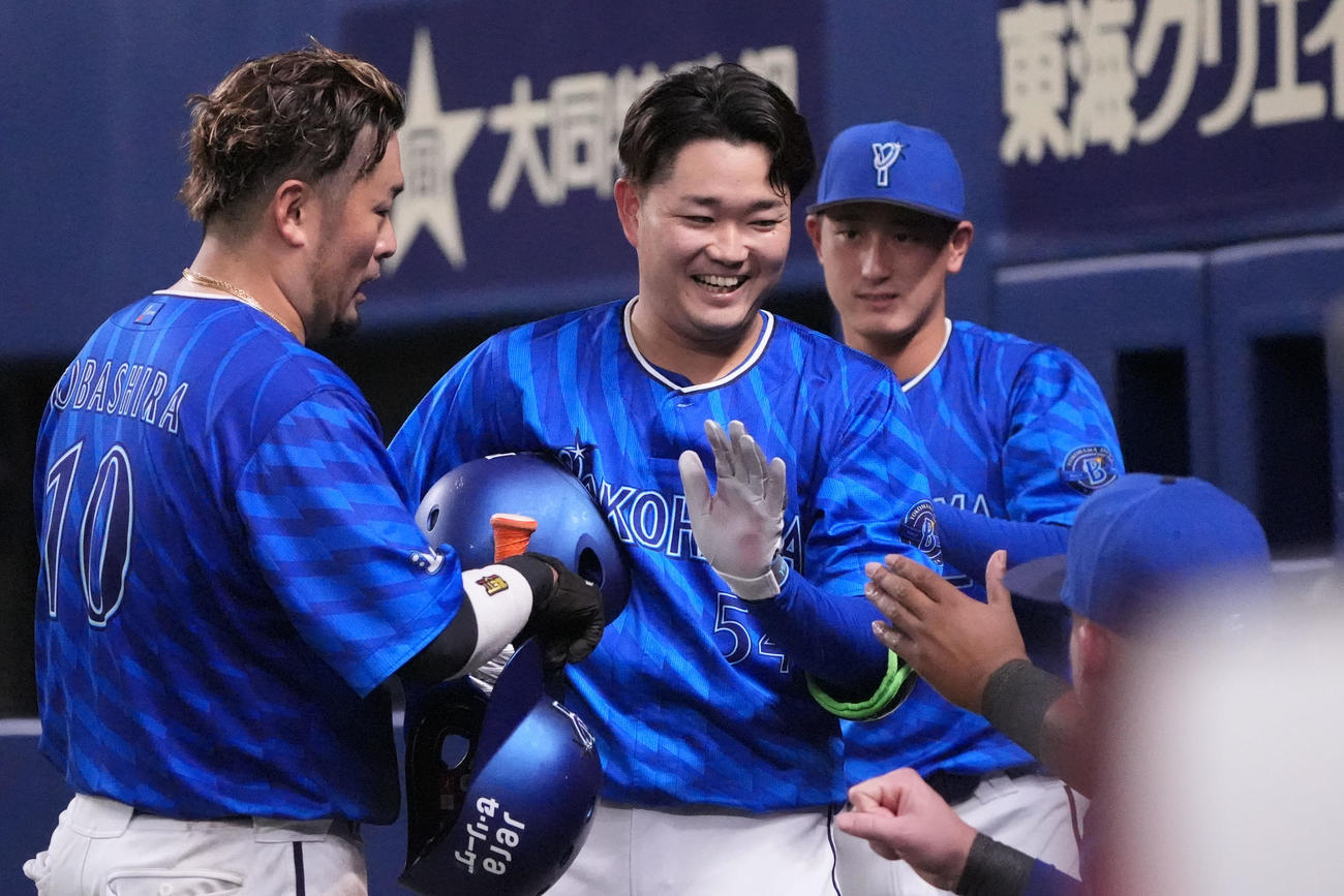 中日対DeNA 6回表DeNA1死二、三塁、石田裕（左から2人目）は笑顔でナインとタッチを交わす（撮影・森本幸一）