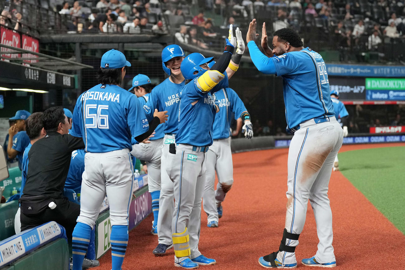 西武対日本ハム　5回表日本ハム1死二、三塁、3点本塁打を放ち生還した水野（中央）（撮影・井上学）