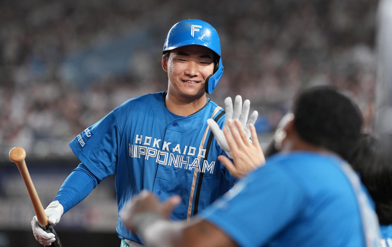 ロッテ対日本ハム　8回表日本ハム無死一、三塁、左犠飛を放った山県はベンチ前でナインと笑顔でハイタッチ（撮影・鈴木みどり）