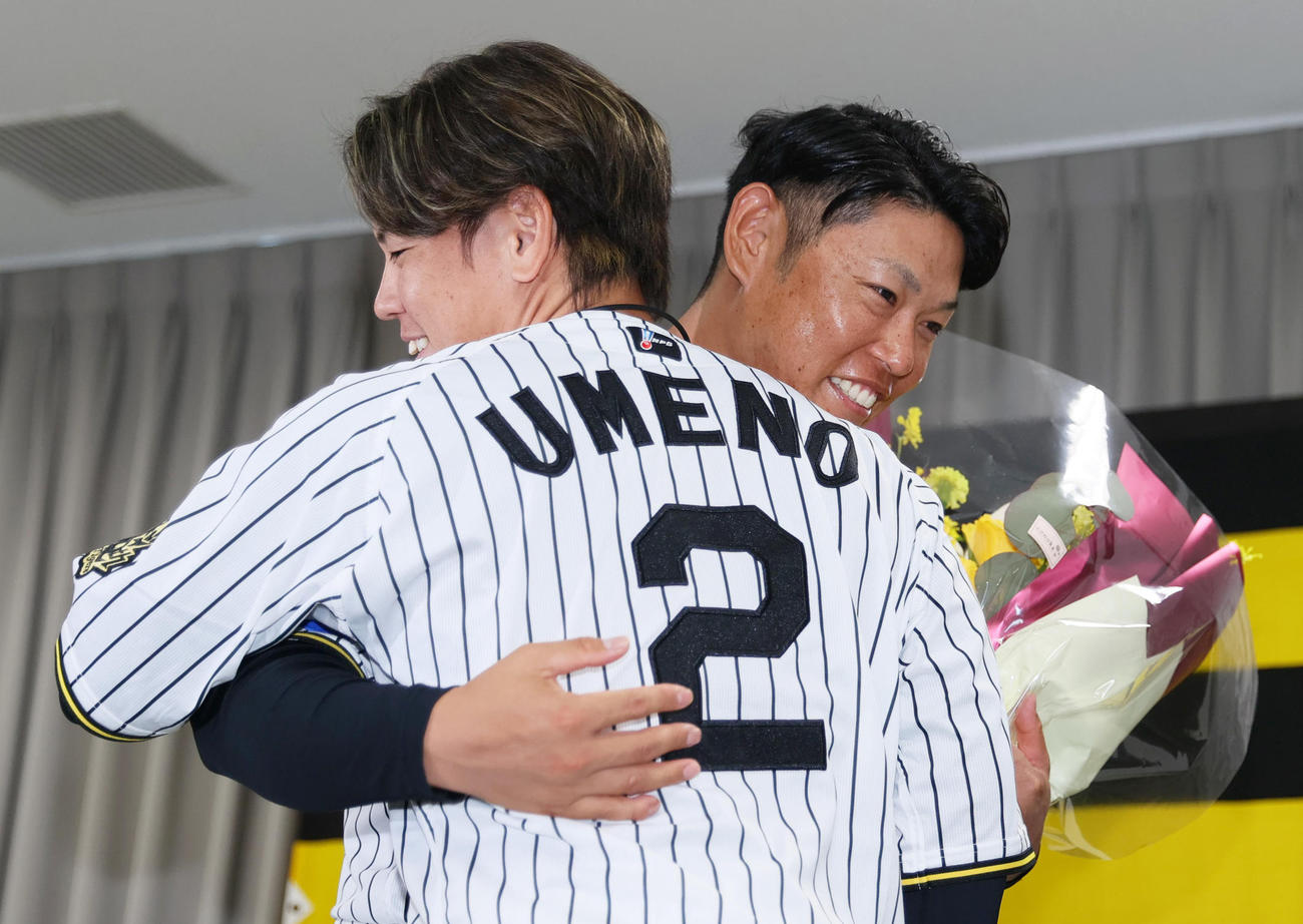 サプライズで登場した梅野（手前）は引退する原口にねぎらいの言葉をかけ抱き合う（撮影・上山淳一）