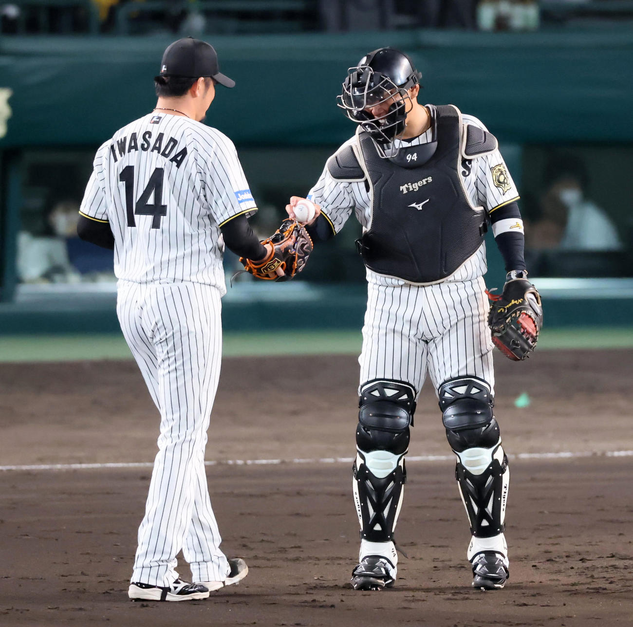 阪神対ヤクルト　9回表ヤクルト無死、守備位置変更で捕手に就いた原口（右）は岩貞へボールを手渡す（撮影・加藤哉）