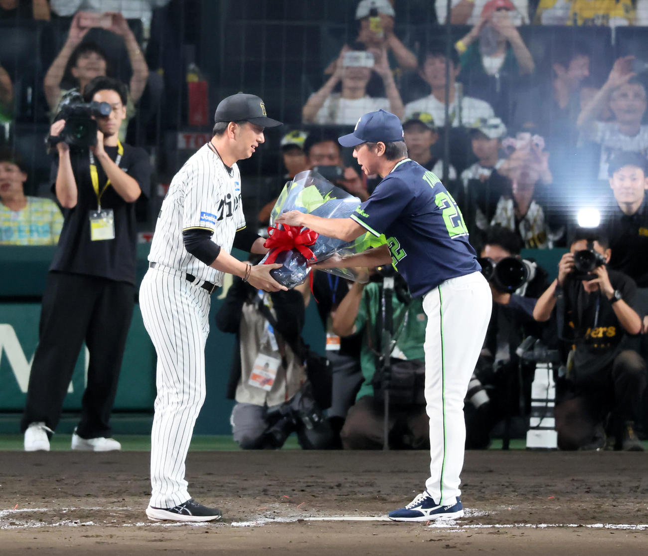 阪神対ヤクルト　試合後ヤクルト高津監督（右）に花束を手渡す阪神藤川監督（撮影・加藤哉）